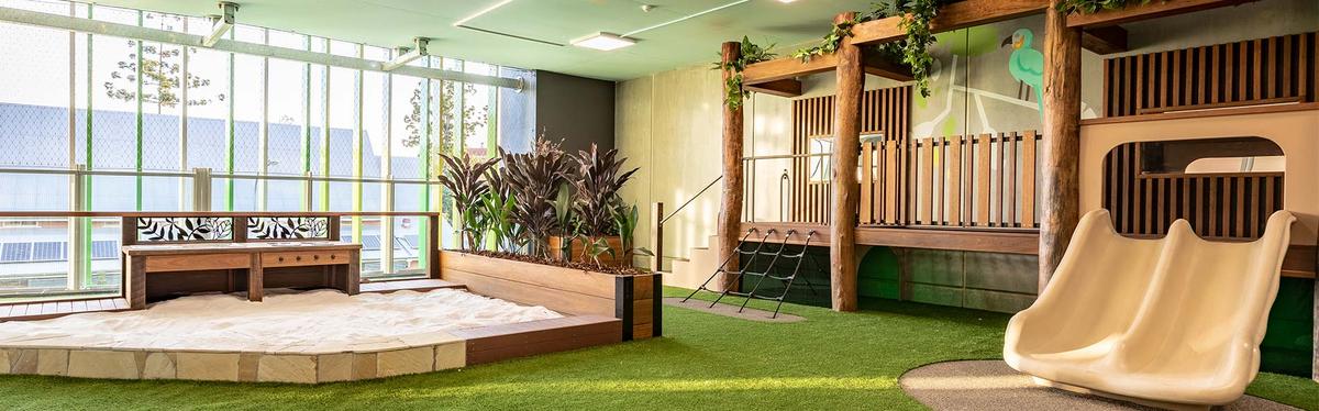 Natural playscape with wooden structures and a focus on eco-friendly play environments.